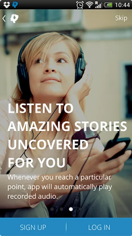 Audiotrip onboarding screen — 'Listen to amazing stories uncovered for you' — over a photo of someone listening on headphones